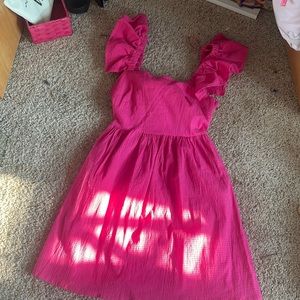 Small pink dress with ruffle shoulders and a tie bow in the back
